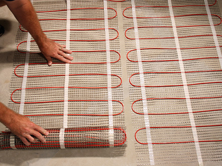 ComfortTile floor heating mats being installed.