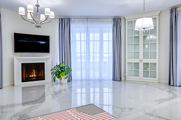 Radiant heated floor with cutaway, showing an illustration of the heating element under the marble. Radiant heated tile floor with cutaway showing the heating cable and thinset.
